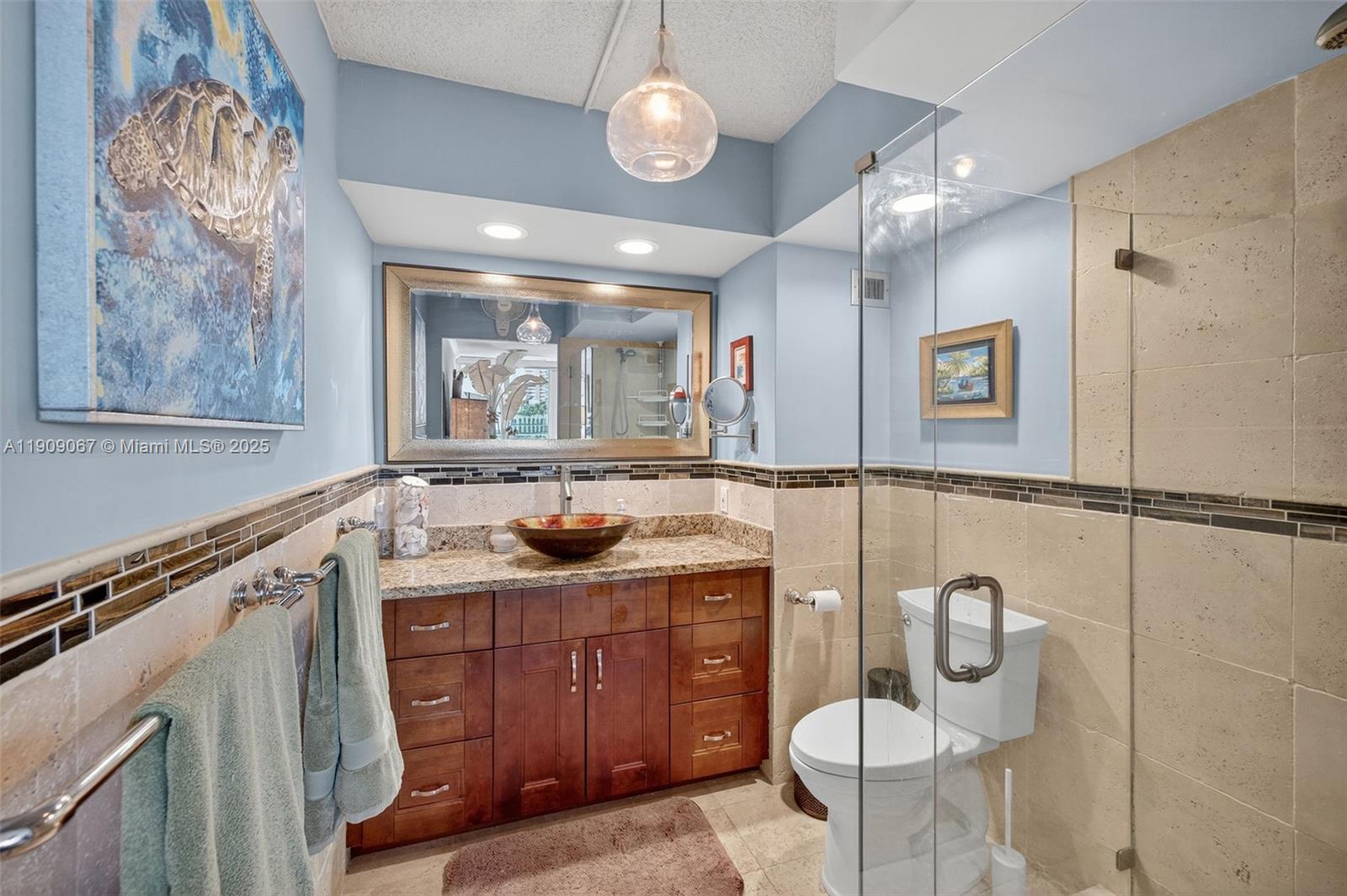 121 Golden Isles Drive, Unit 205 Hallandale Beach, FL 33009 - Photo 17 of 82 a bathroom with a sink vanity granite and toilet