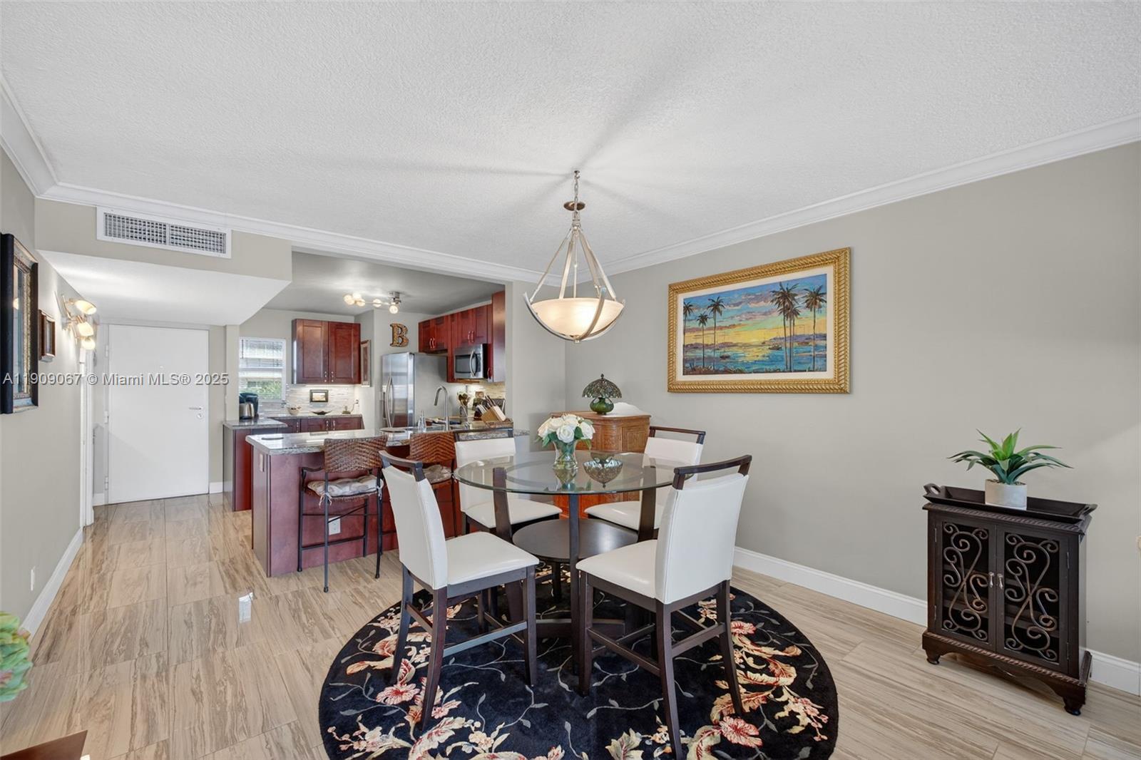 121 Golden Isles Drive, Unit 205 Hallandale Beach, FL 33009 - Photo 23 of 82 a view of a dining room with furniture and wooden floor