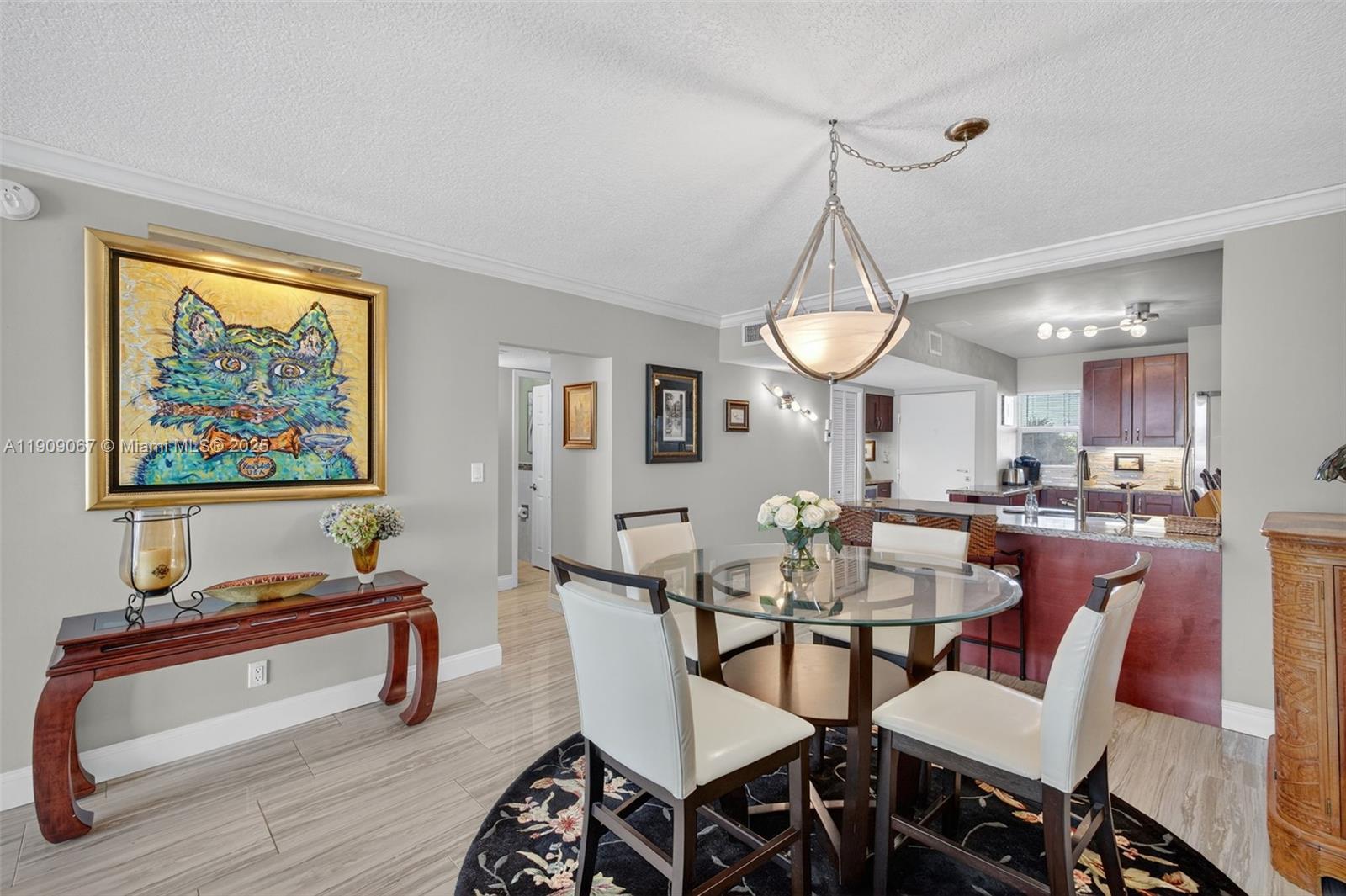 121 Golden Isles Drive, Unit 205 Hallandale Beach, FL 33009 - Photo 24 of 82 a view of a dining room with furniture window and wooden floor