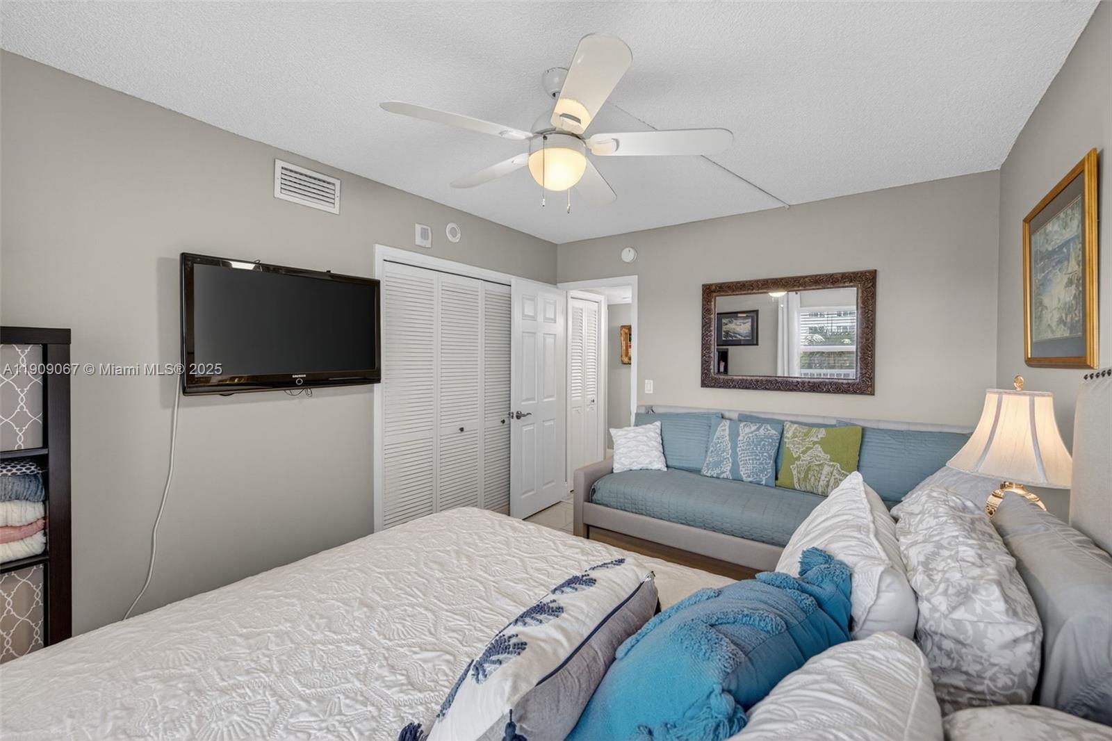 121 Golden Isles Drive, Unit 205 Hallandale Beach, FL 33009 - Photo 31 of 82 a living room with furniture and a flat screen tv