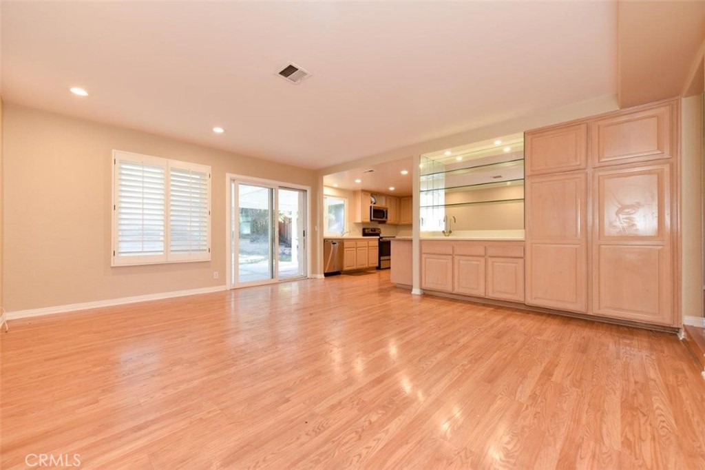 15052 Clemons Circle Irvine, CA 92604 - Photo 13 of 38 a view of an empty room with a window and wooden floor