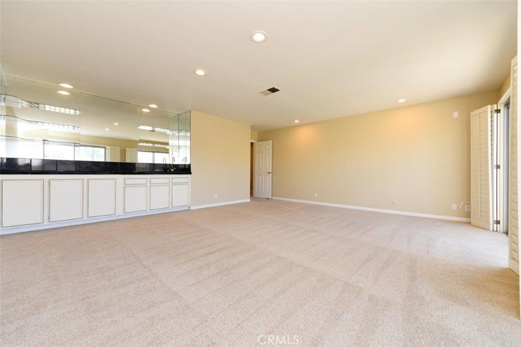 15052 Clemons Circle Irvine, CA 92604 - Photo 22 of 38 a view of an empty room with a kitchen