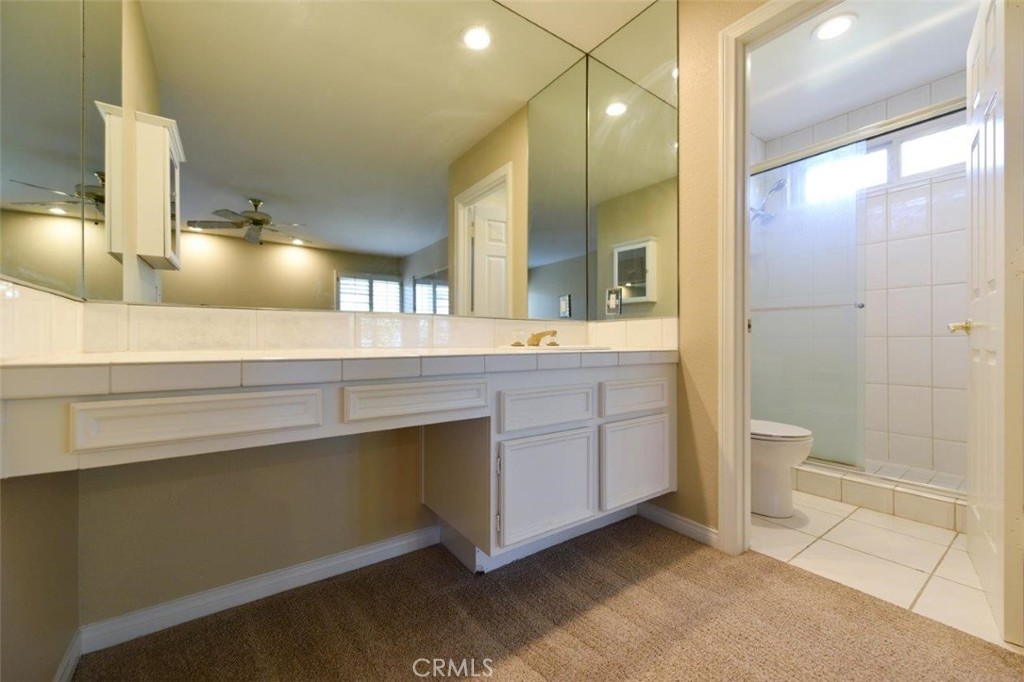 15052 Clemons Circle Irvine, CA 92604 - Photo 31 of 38 a bathroom with a sink a toilet and shower