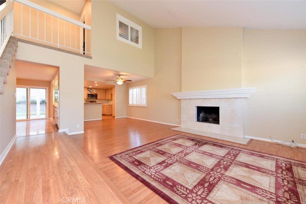 15052 Clemons Circle Irvine, CA 92604 - Photo 5 of 38 a view of an empty room with wooden floor and a fireplace