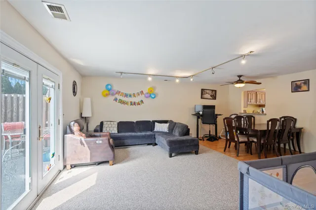 a living room with furniture and kitchen view