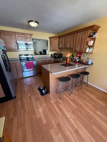 a room with wooden floors and wooden cabinets