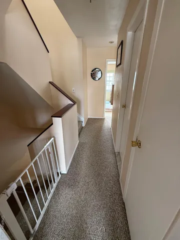 a view of a hallway with staircase