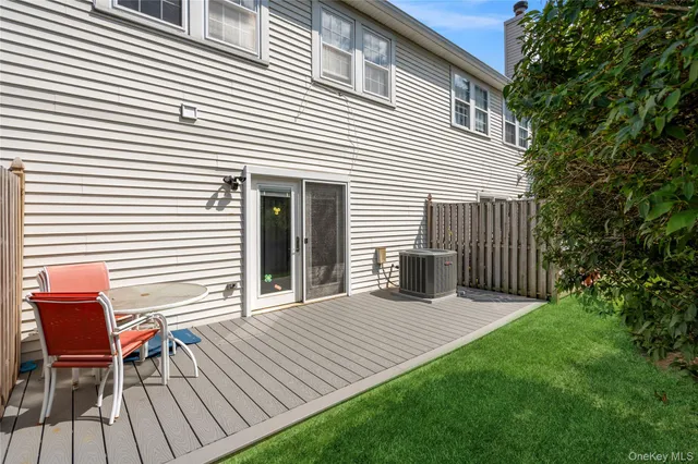 a view of a chair and table in the back yard