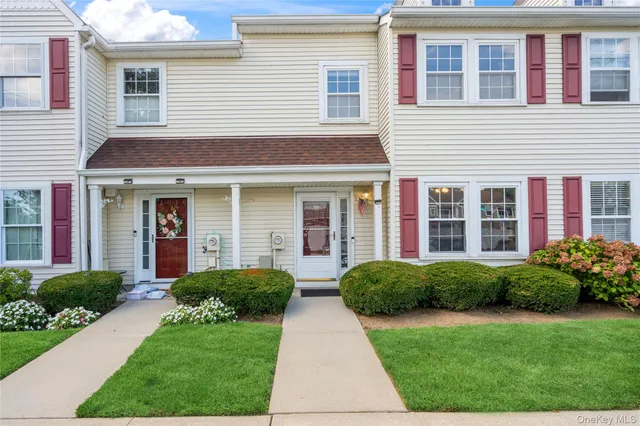a front view of house and yard with green space