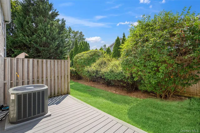 a view of a backyard with wooden floor and fence
