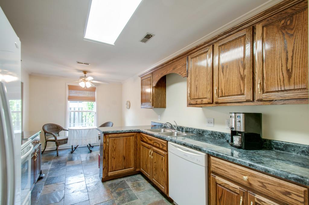 1101 General George Patton Road, Unit 1101 Nashville, TN 37221 - Photo 12 of 30 a kitchen with granite countertop cabinets stainless steel appliances a sink and a counter top space