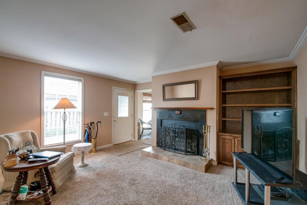 1101 General George Patton Road, Unit 1101 Nashville, TN 37221 - Photo 19 of 30 a living room with furniture and a fireplace