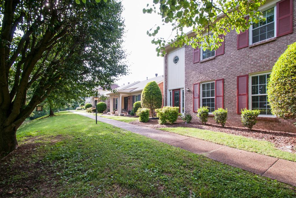 1101 General George Patton Road, Unit 1101 Nashville, TN 37221 - Photo 2 of 30 a front view of a house with a yard and porch