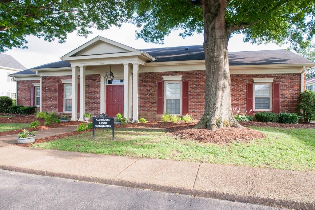1101 General George Patton Road, Unit 1101 Nashville, TN 37221 - Photo 30 of 30 front view of a brick house with a yard and large trees