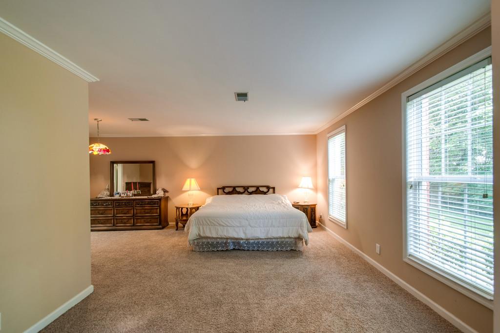 1101 General George Patton Road, Unit 1101 Nashville, TN 37221 - Photo 7 of 30 a bedroom with a bed and a window