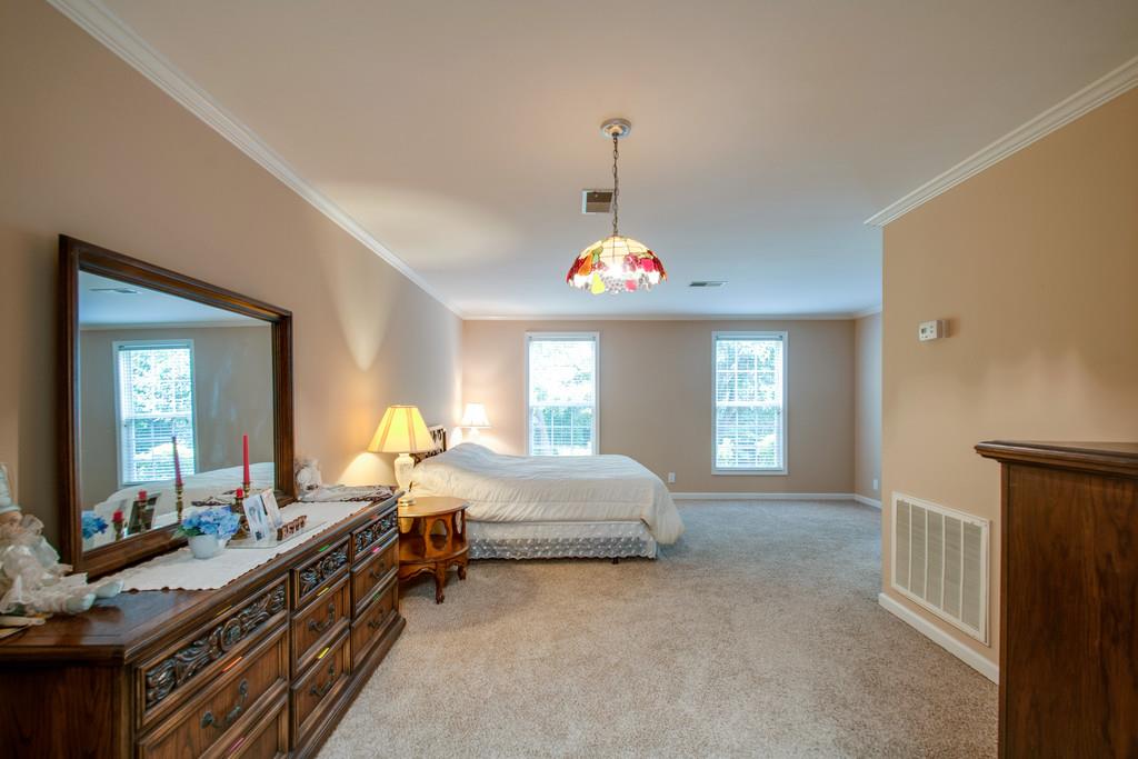 1101 General George Patton Road, Unit 1101 Nashville, TN 37221 - Photo 8 of 30 a spacious bedroom with a bed and a chandelier