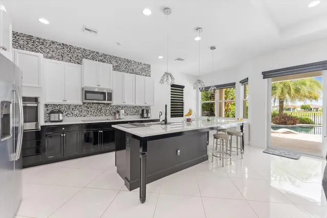 a kitchen with a stove a sink and a refrigerator