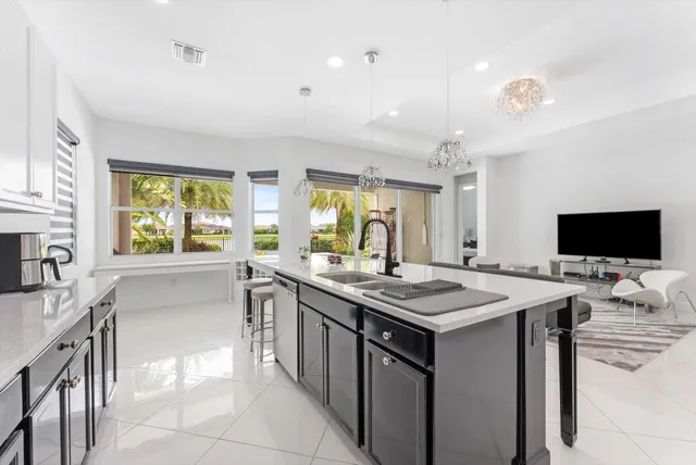 a kitchen with a sink refrigerator and microwave