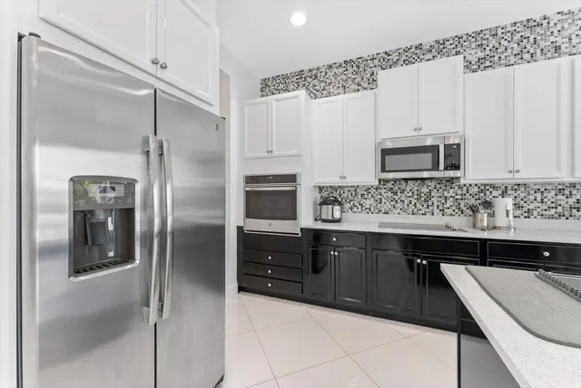 a large white kitchen with a large window