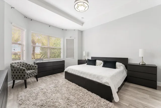 a bedroom with a bed and a chandelier