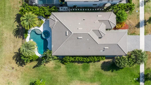 an aerial view of a house with a yard and potted plants
