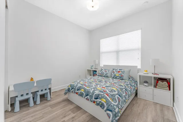 a bedroom with a bed and a dresser in it