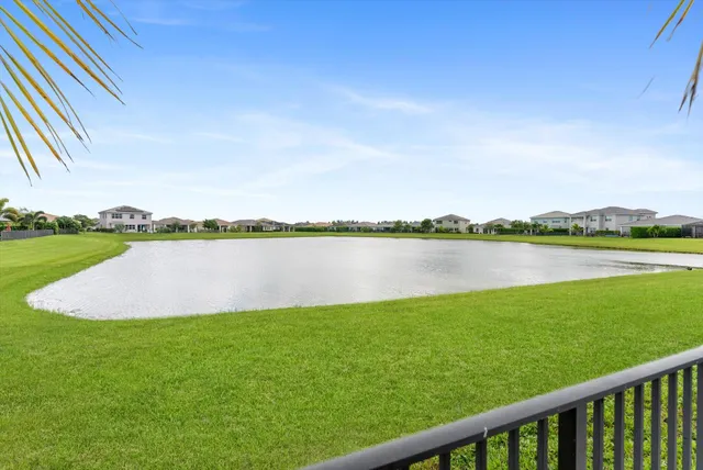 a view of a house with swimming pool and sitting area