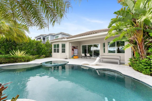 swimming pool view with a garden space