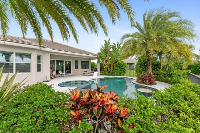 a view of a house with a yard and a garden