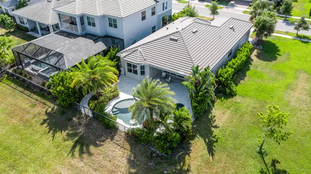 an aerial view of a house with swimming pool and porch with furniture