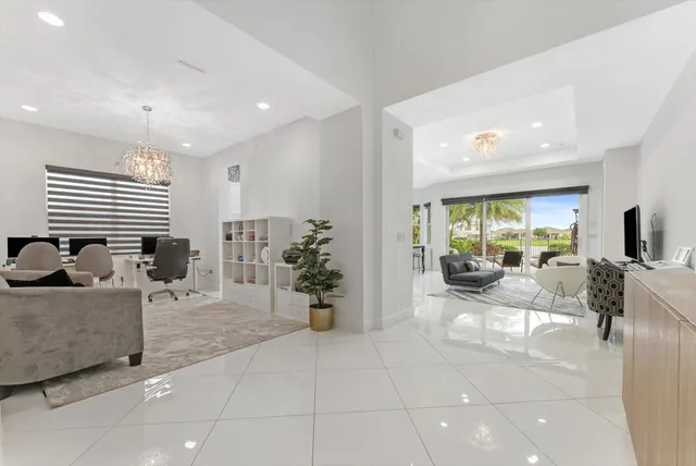 a living room with furniture and a chandelier