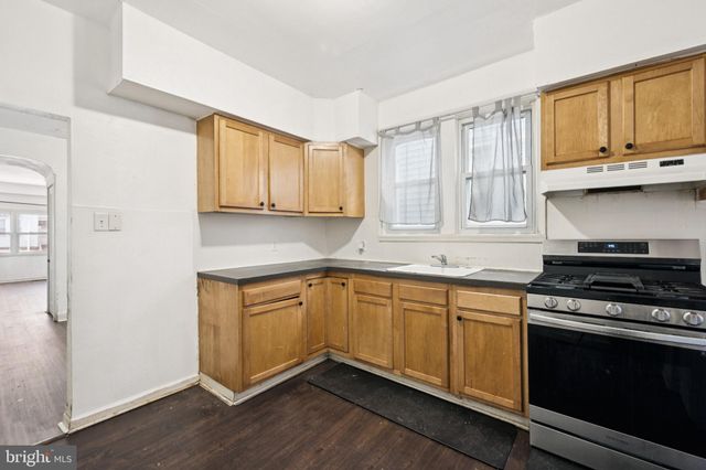 a kitchen with stainless steel appliances granite countertop a stove and a sink