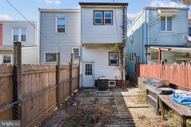 a view of a brick house with many windows