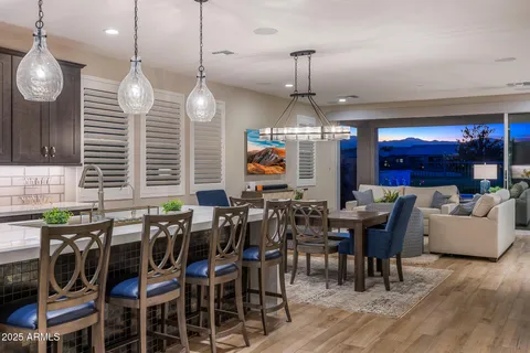 an open kitchen with dining table and chairs