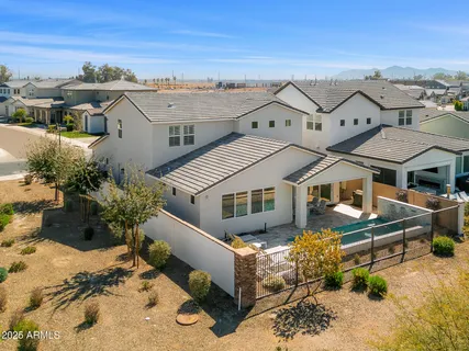 an aerial view of a house with a yard