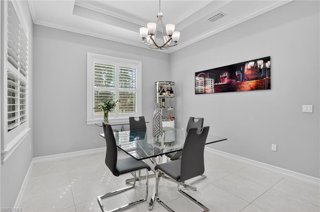 2642 10th Avenue Northeast Naples, FL 34120 - Photo 13 of 38 a dining room with furniture and window