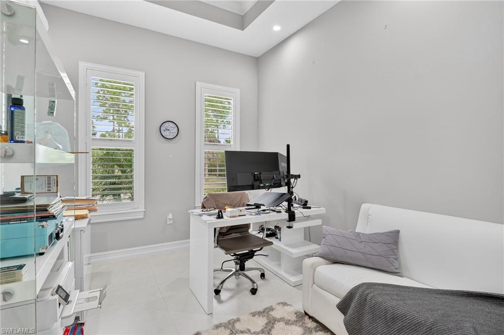2642 10th Avenue Northeast Naples, FL 34120 - Photo 14 of 38 a living room with furniture and a flat screen tv