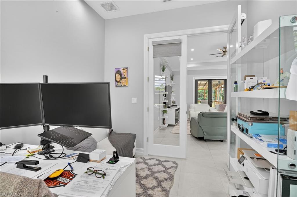 2642 10th Avenue Northeast Naples, FL 34120 - Photo 15 of 38 a living room with furniture and a flat screen tv