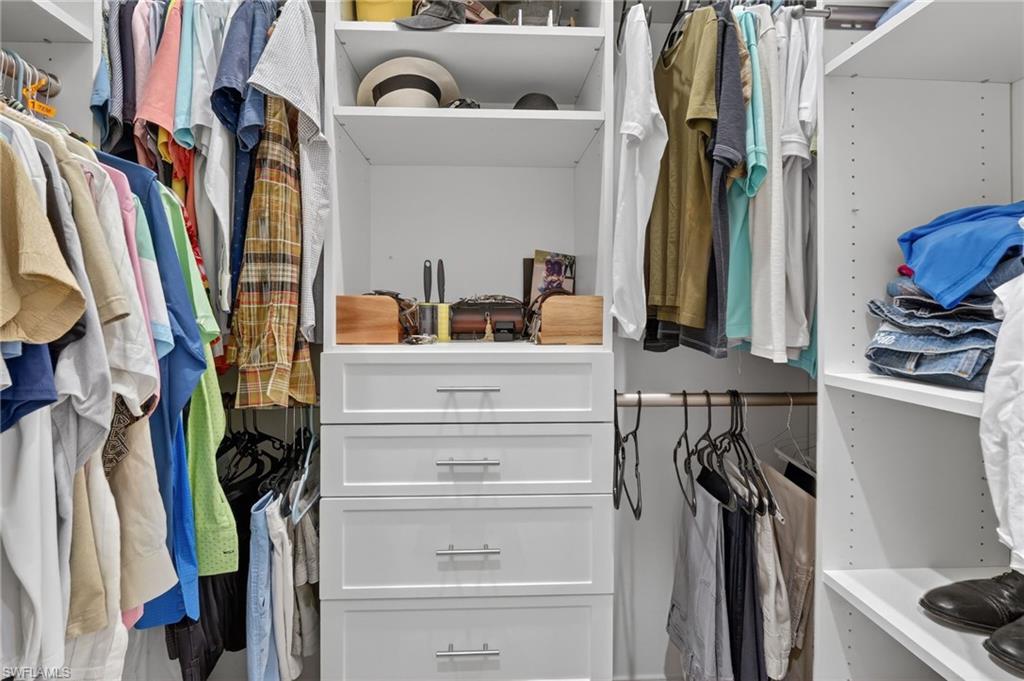 2642 10th Avenue Northeast Naples, FL 34120 - Photo 20 of 38 a view of walk in closet with clothes and shoes