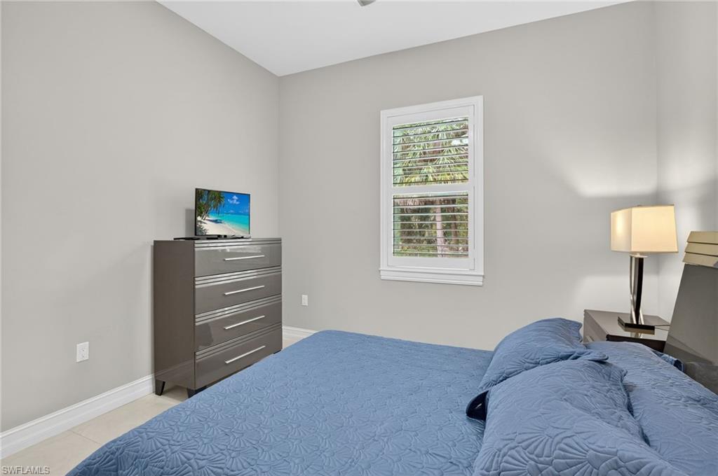 2642 10th Avenue Northeast Naples, FL 34120 - Photo 25 of 38 a bedroom with a bed and a window