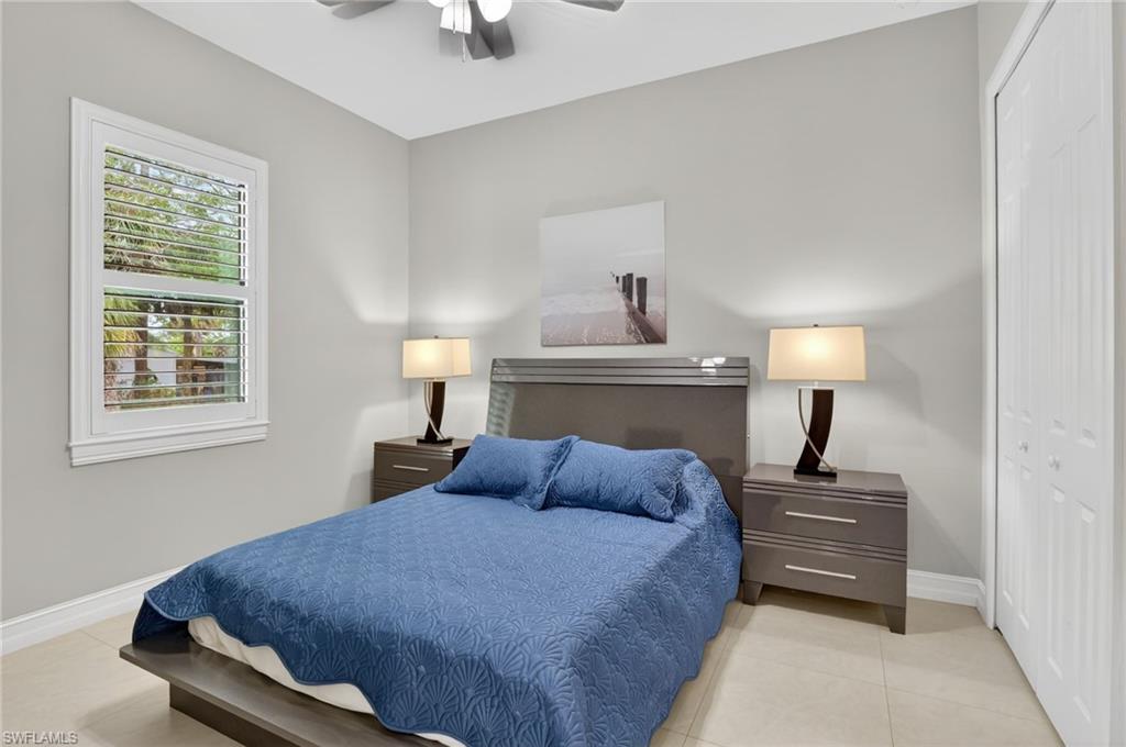 2642 10th Avenue Northeast Naples, FL 34120 - Photo 26 of 38 a bedroom with a bed and wooden floor