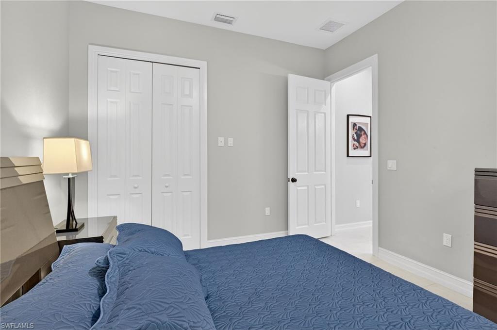 2642 10th Avenue Northeast Naples, FL 34120 - Photo 27 of 38 a living room with furniture and a lamp