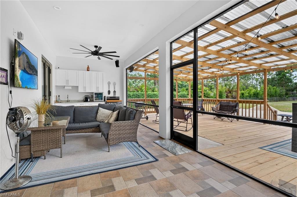 2642 10th Avenue Northeast Naples, FL 34120 - Photo 30 of 38 a living room with furniture and a large window