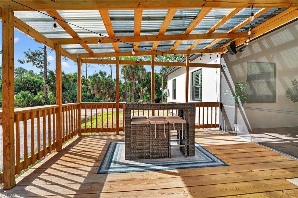 2642 10th Avenue Northeast Naples, FL 34120 - Photo 33 of 38 a view of a porch with wooden floor