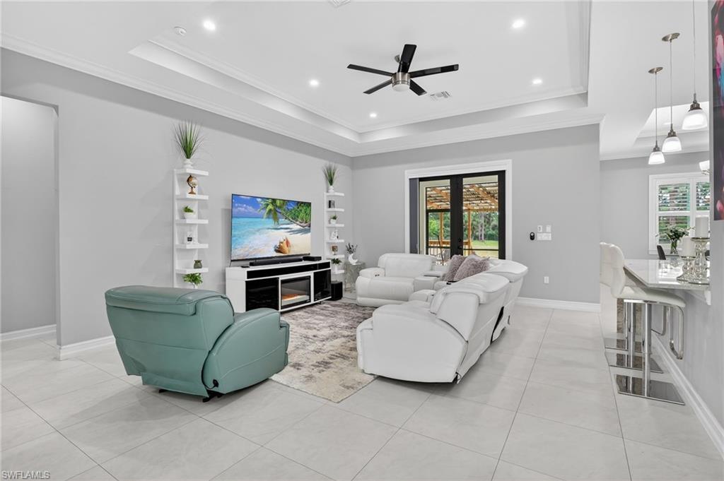 2642 10th Avenue Northeast Naples, FL 34120 - Photo 4 of 38 a living room with furniture and a large window
