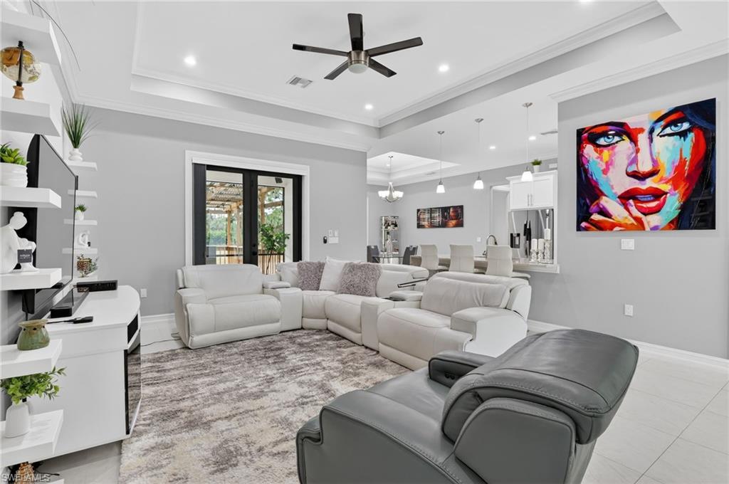 2642 10th Avenue Northeast Naples, FL 34120 - Photo 5 of 38 a living room with furniture and a large window