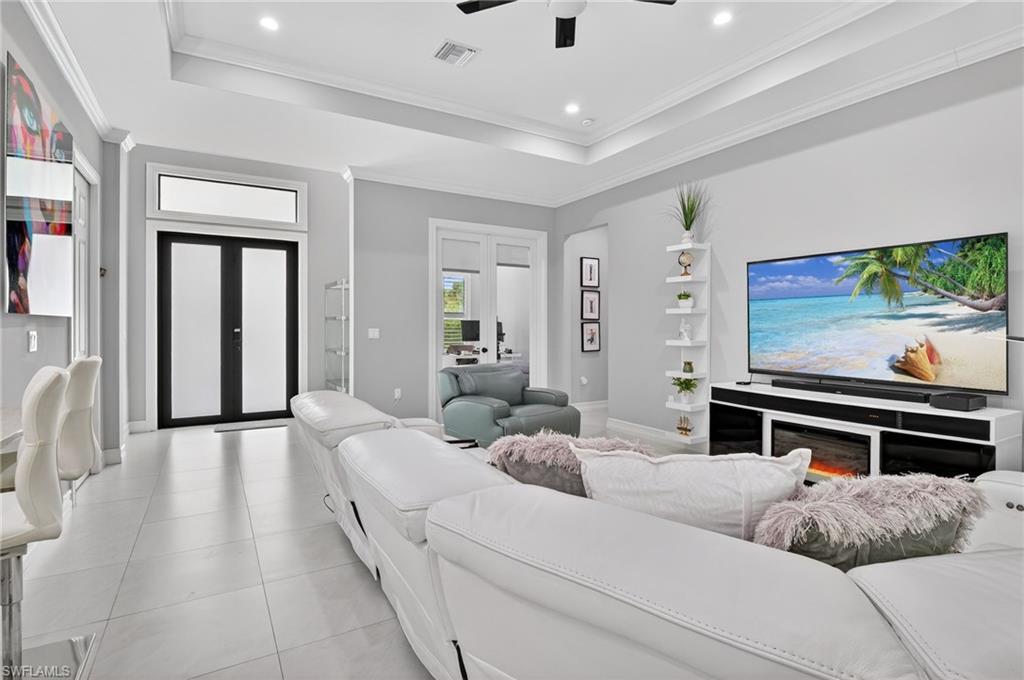2642 10th Avenue Northeast Naples, FL 34120 - Photo 6 of 38 a living room with furniture and a flat screen tv