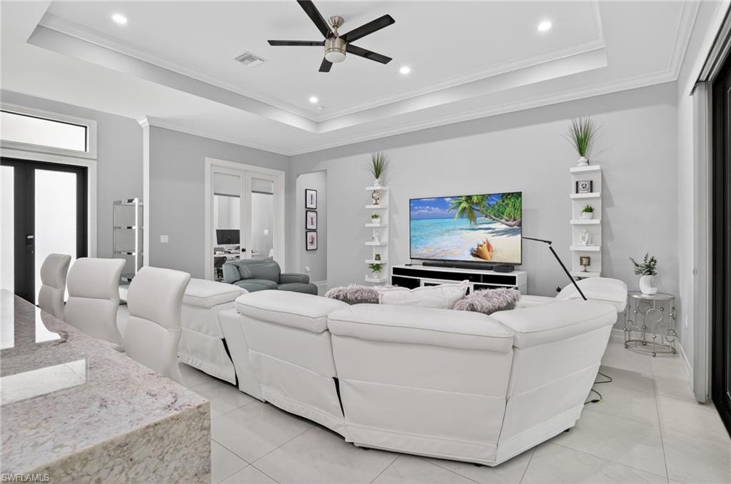 2642 10th Avenue Northeast Naples, FL 34120 - Photo 7 of 38 a living room with furniture and a flat screen tv