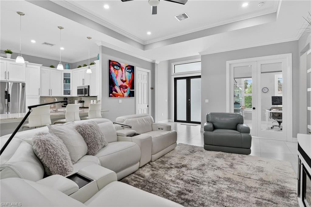 2642 10th Avenue Northeast Naples, FL 34120 - Photo 8 of 38 a living room with furniture and a large window