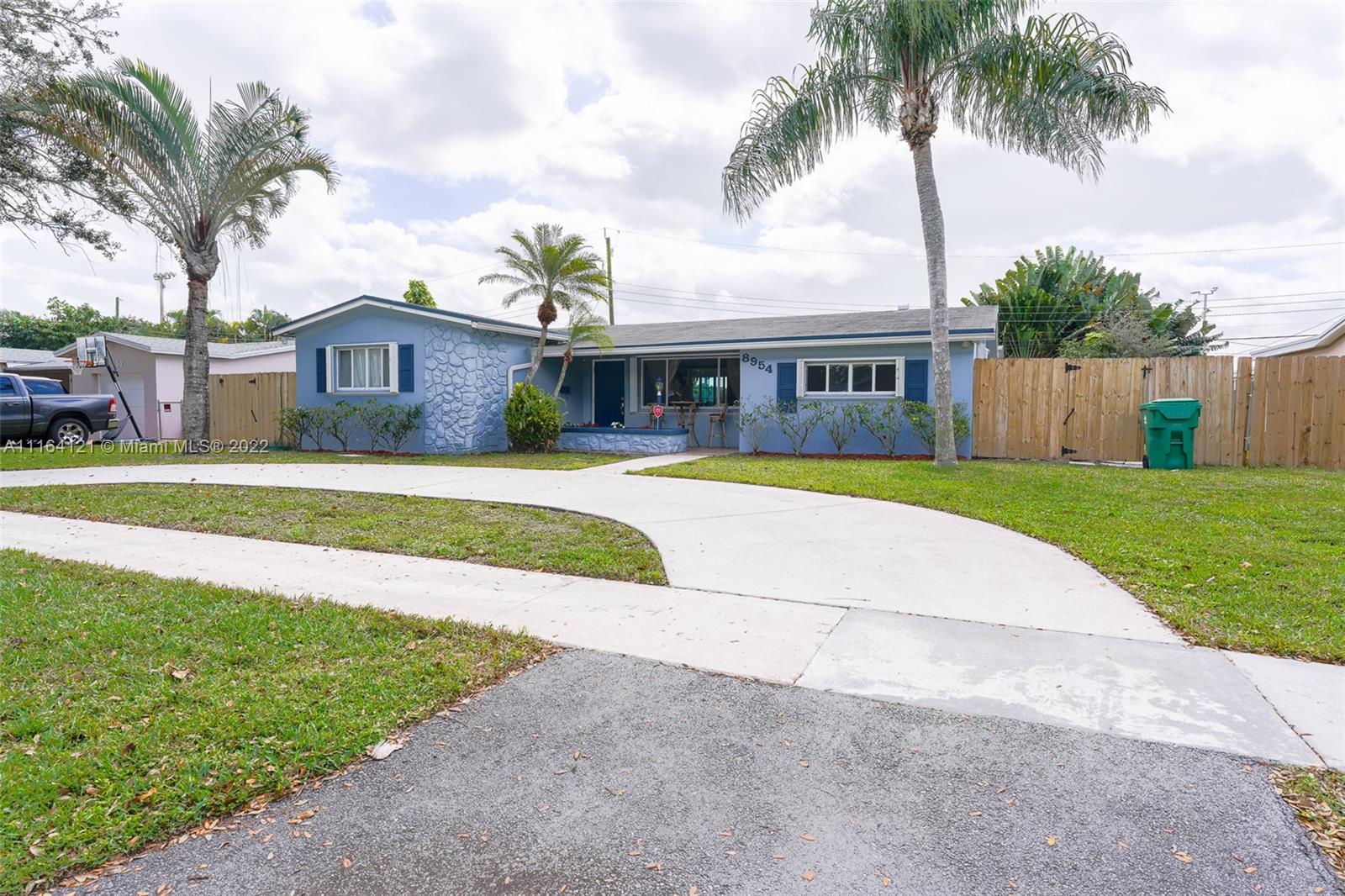 a view of a house with a swimming pool and a big yard